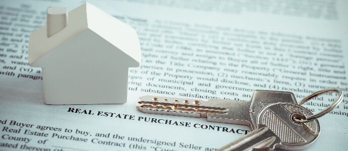 White house and keys on top of purchase contract, Real Estate Law