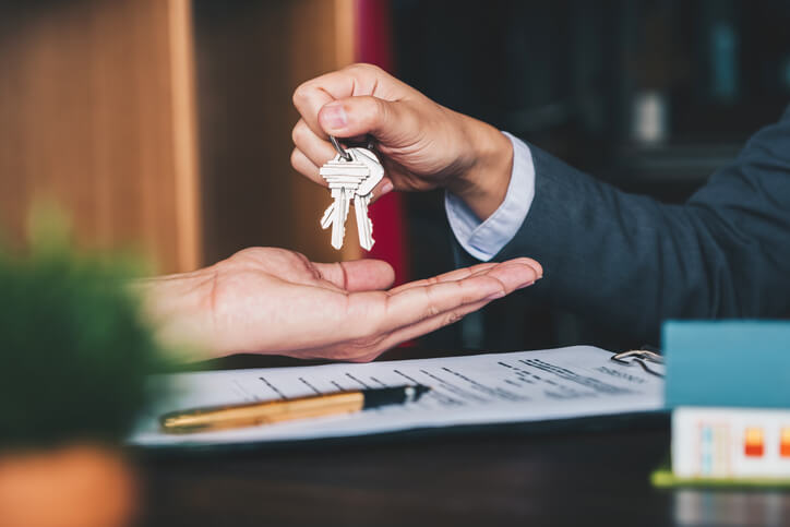 Real estate client being handed keys