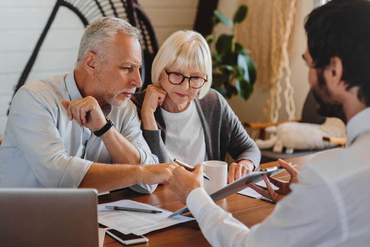 Elderly couple sitting with estate planning attorney