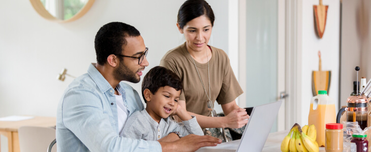 A family looking at a computer