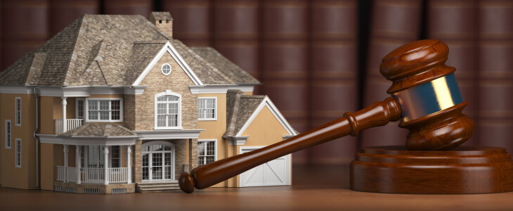 A gavel with a small house